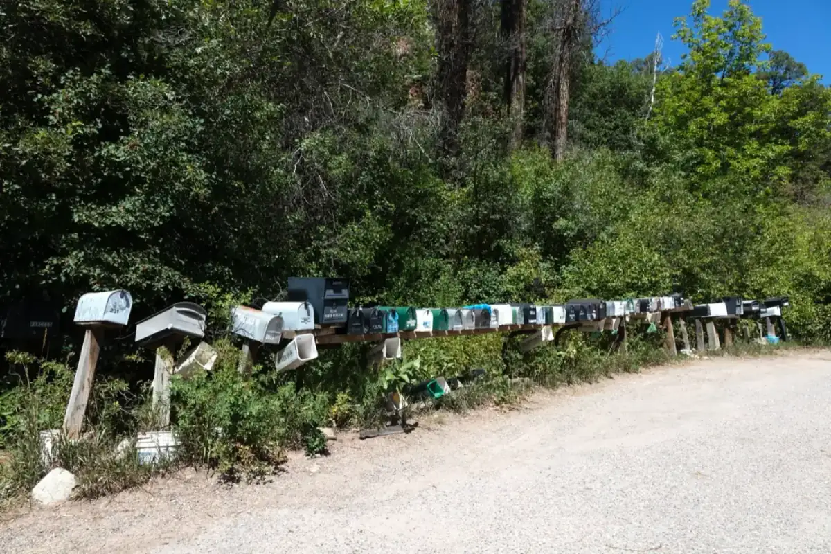 A long row of rural mailboxes along a gravel road in Colorado, where offer letters for minerals arrive