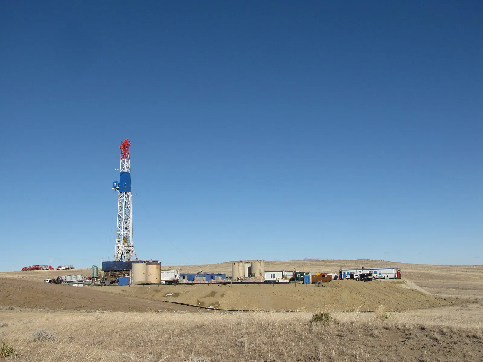 Oil and gas in Wyoming: a drilling rig on a well pad under a clear sky in Converse County, Wyoming