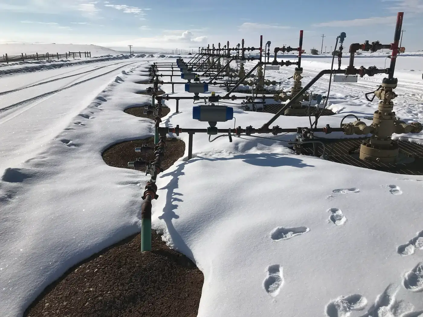 Oil and gas in Utah: a row of gas wellheads in the snow in the Vernal Field Office area of northeastern Utah