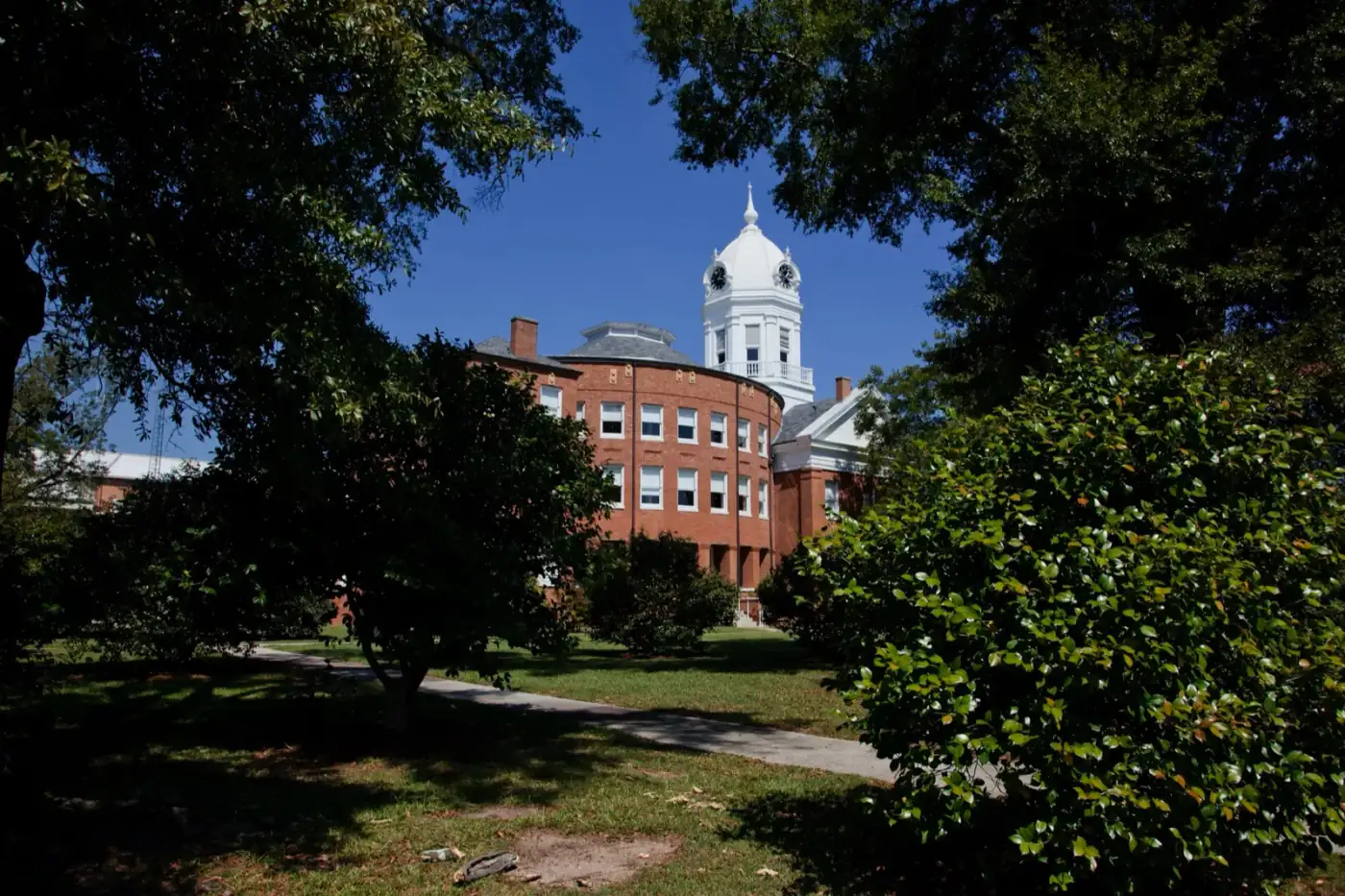 The historic Monroe County Courthouse in Monroeville, Alabama, framed by trees