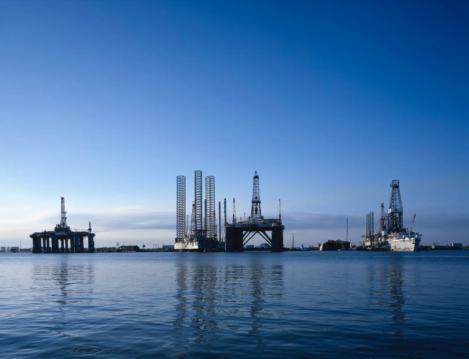 Offshore drilling rigs standing in calm water at Galveston, Texas