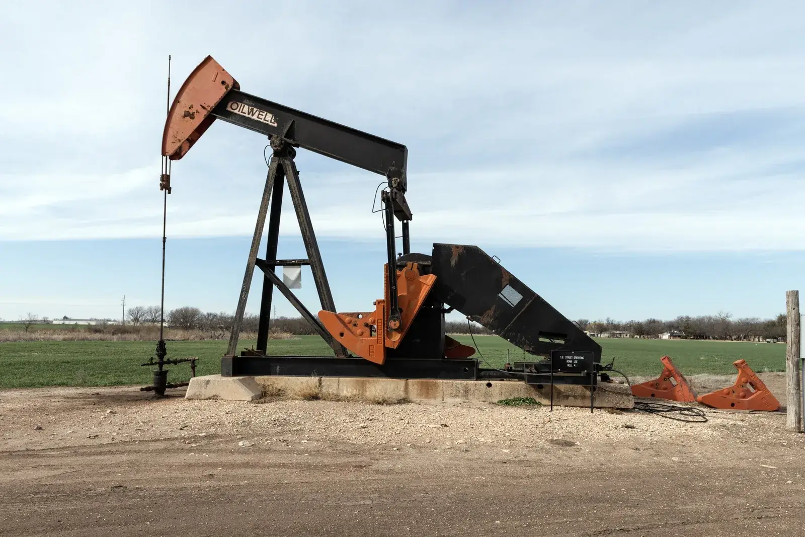 Sell oil and gas royalties: a painted pumpjack beside U.S. 83 near Winters, Runnels County, Texas